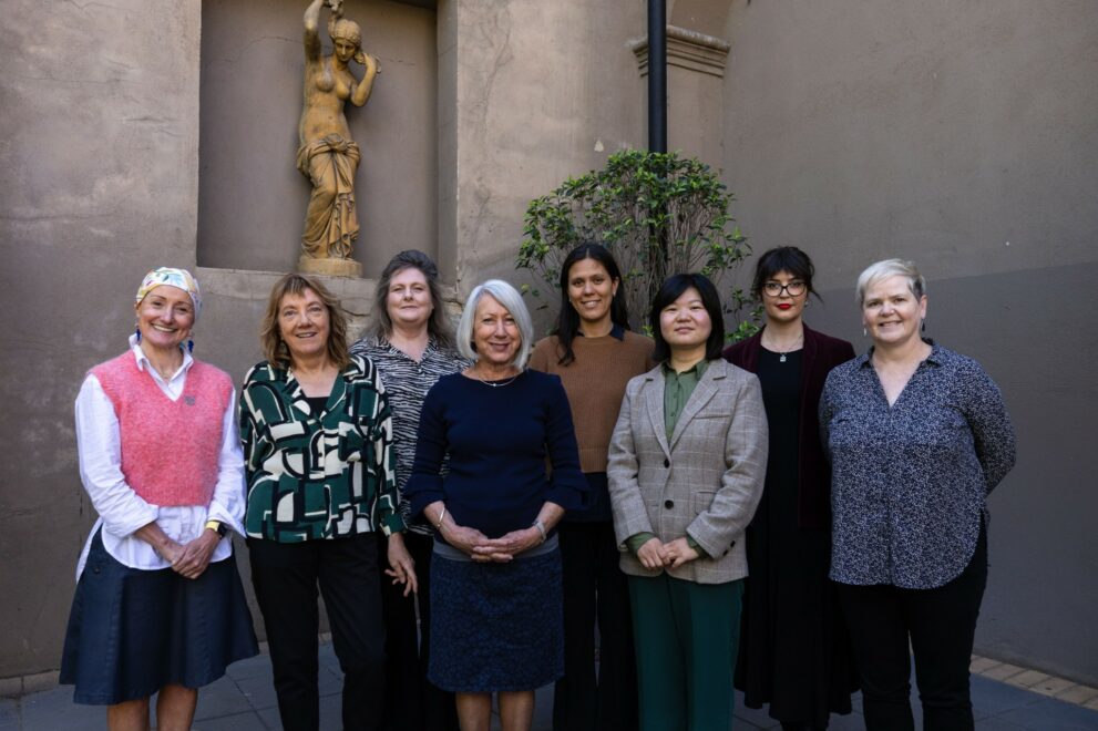 Photo of a group of people standing and smiling at the camera.